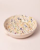 Closeup details of the La Ceramica Vincenzo Del Monaco Colored Drops Large Salad Bowl on light color background.