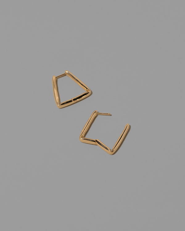 Detail view of the Gold Bend Hoop Earrings on light color background.