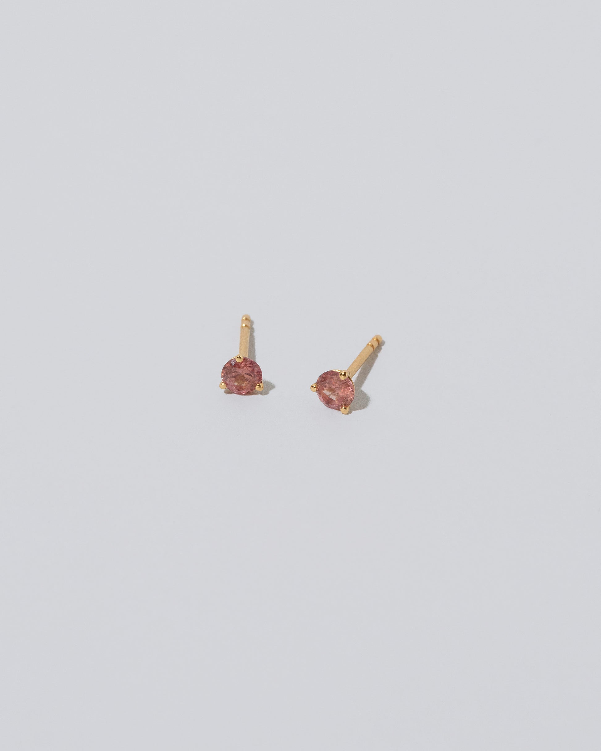 Martini Stud - Coral Sapphire on light color background.