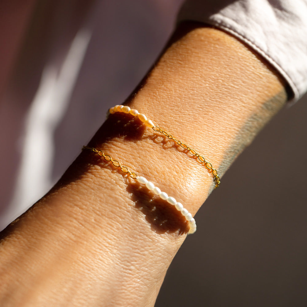 product_details::Half Oval Chain & Peony Seed Pearl Bracelet and Half Oval Chain & White Seed Pearl Bracelets on model.