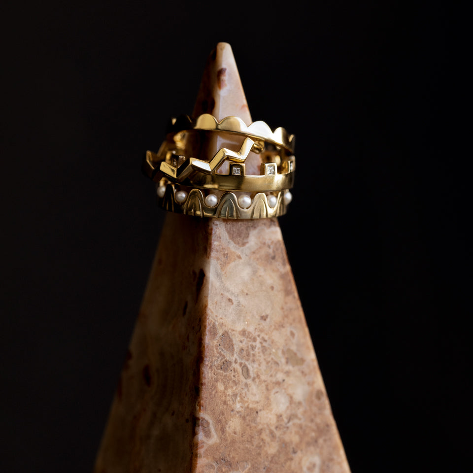 product_details::Styled image featuring the Gold Perfect Balance Band, Gold Eternal Moon Band, Gold White Diamond Connection Band and Gold Pearls of Wisdom Bands.