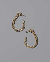 CRZM Gold Landform Hoop Earrings on light color background.