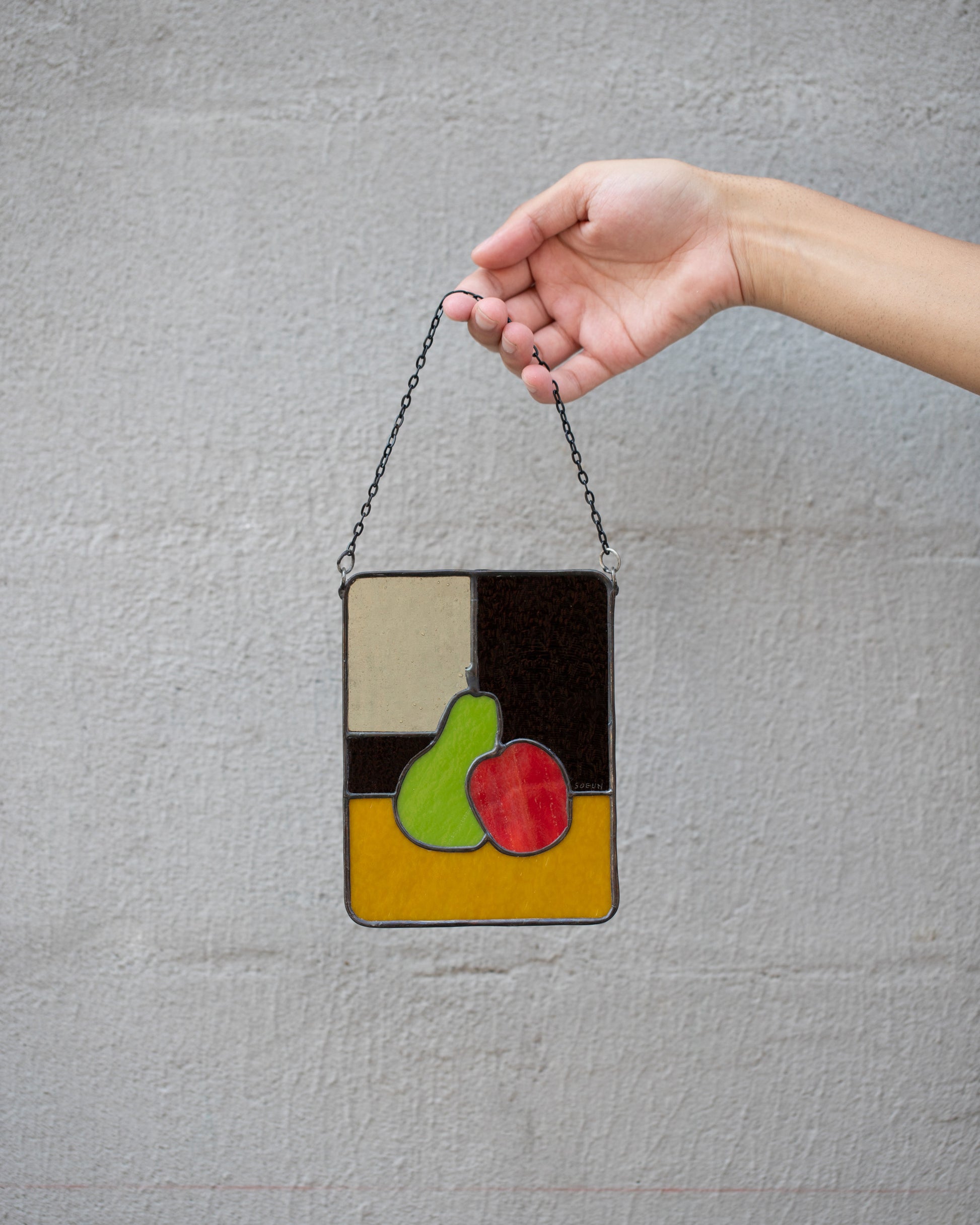 Soeun Lee Bosc and Red Delicious Mini Pear & Apple Stained Glass on light color background.