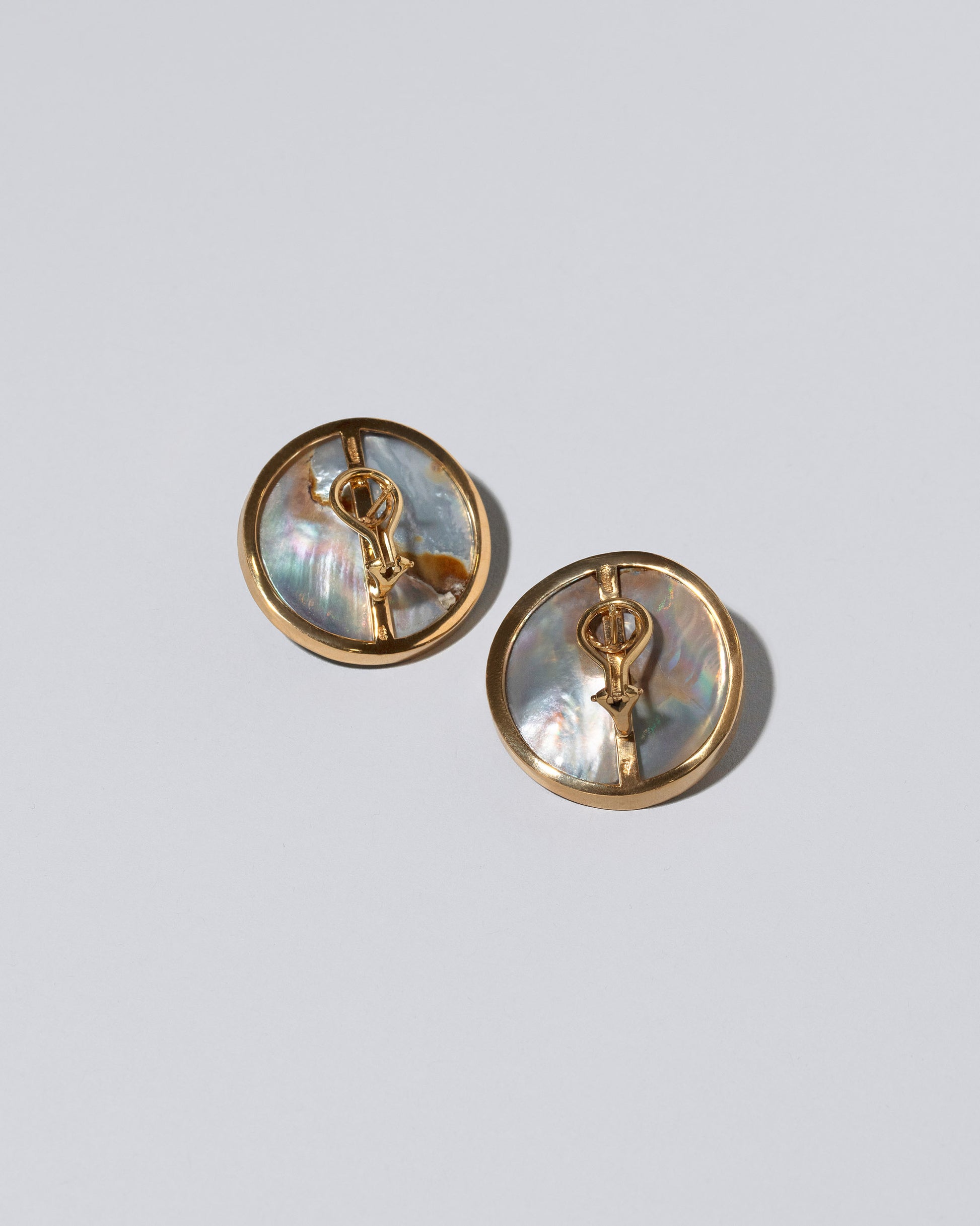 View from the back of the Seeing the Unseen Earrings on light color background.