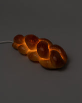 In-use detail view of the Pampshade Challah Lamp on light color background.