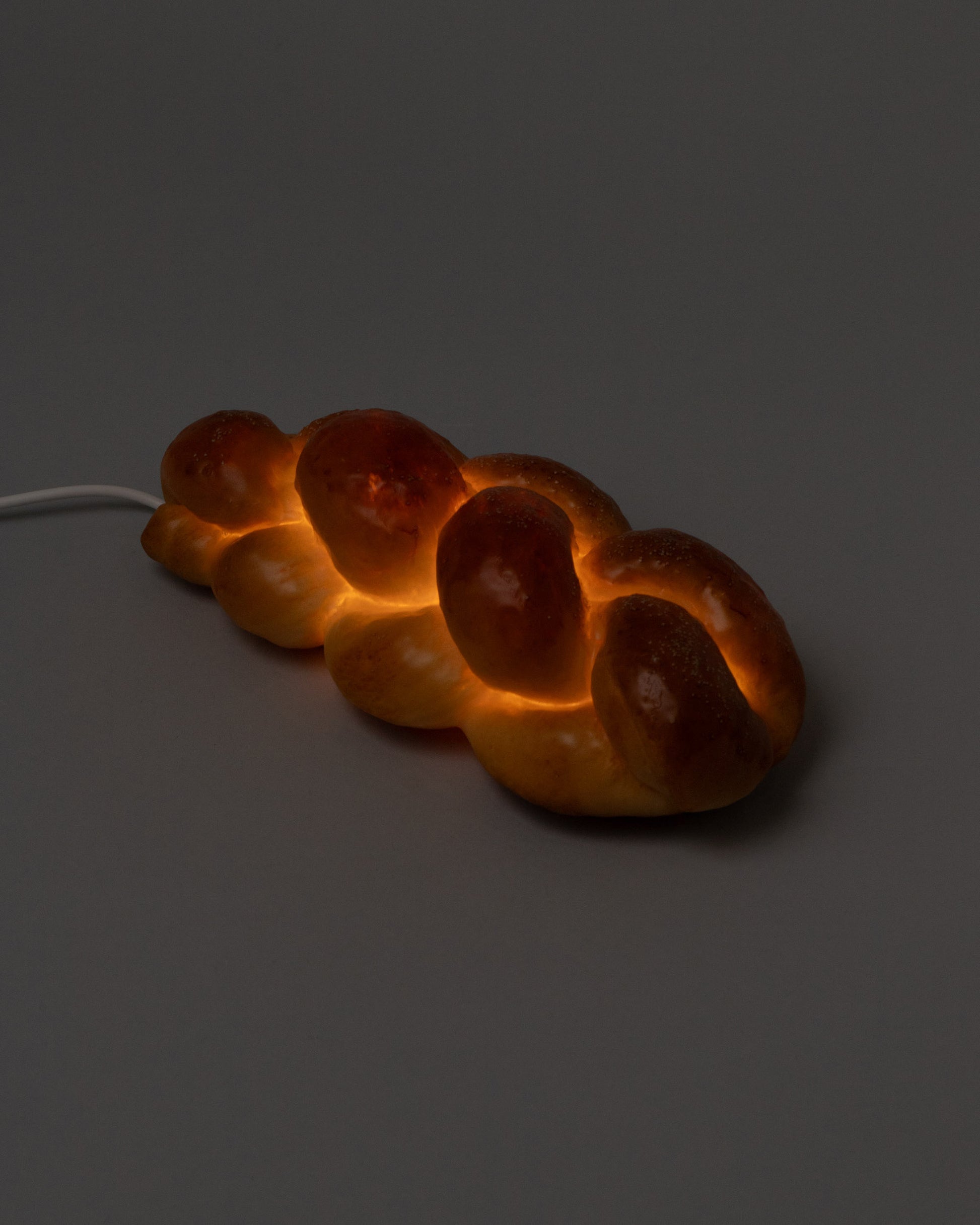 In-use detail view of the Pampshade Challah Lamp on light color background.