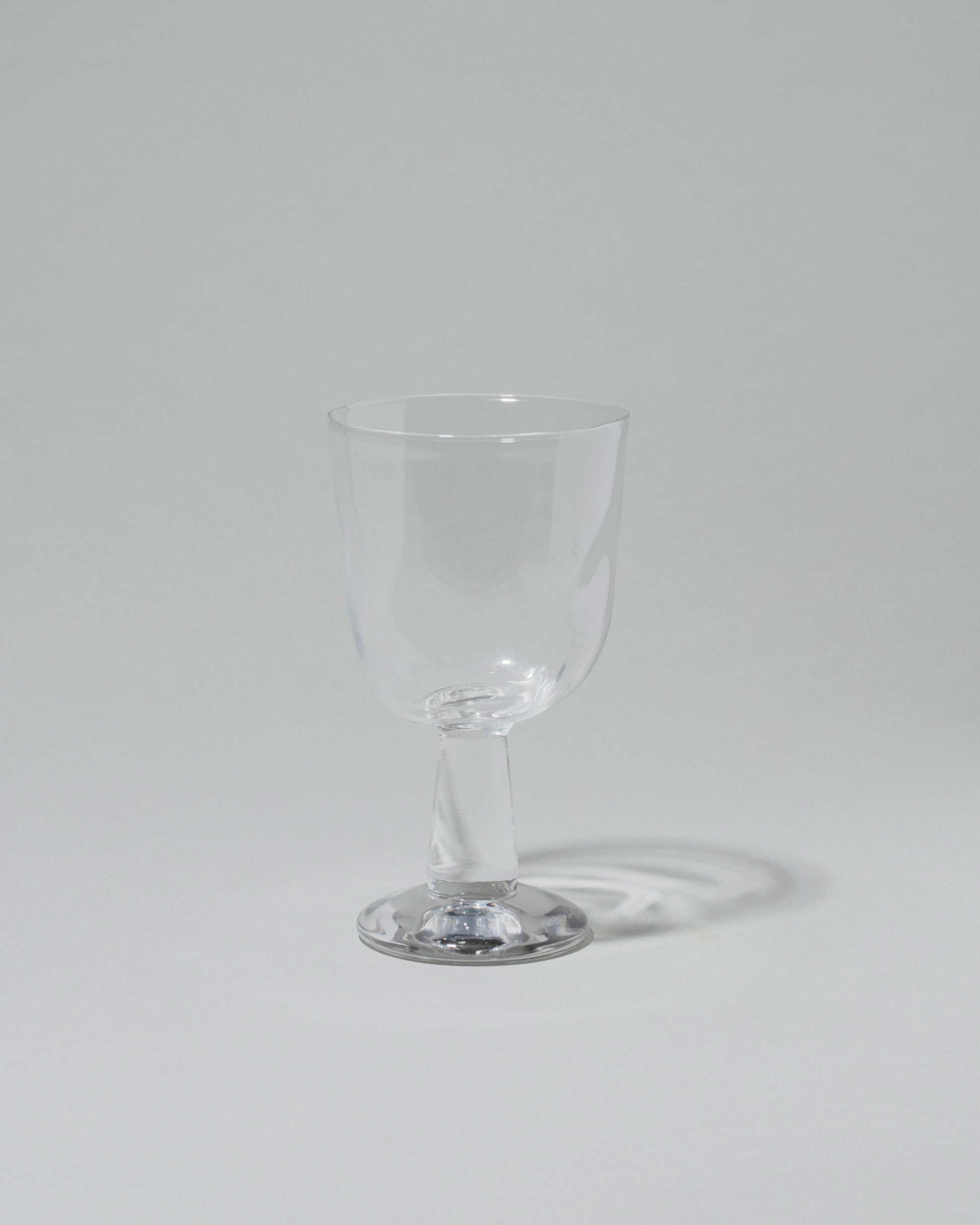 Silje Lindrup Twisted Liqueur Glass on light color background.