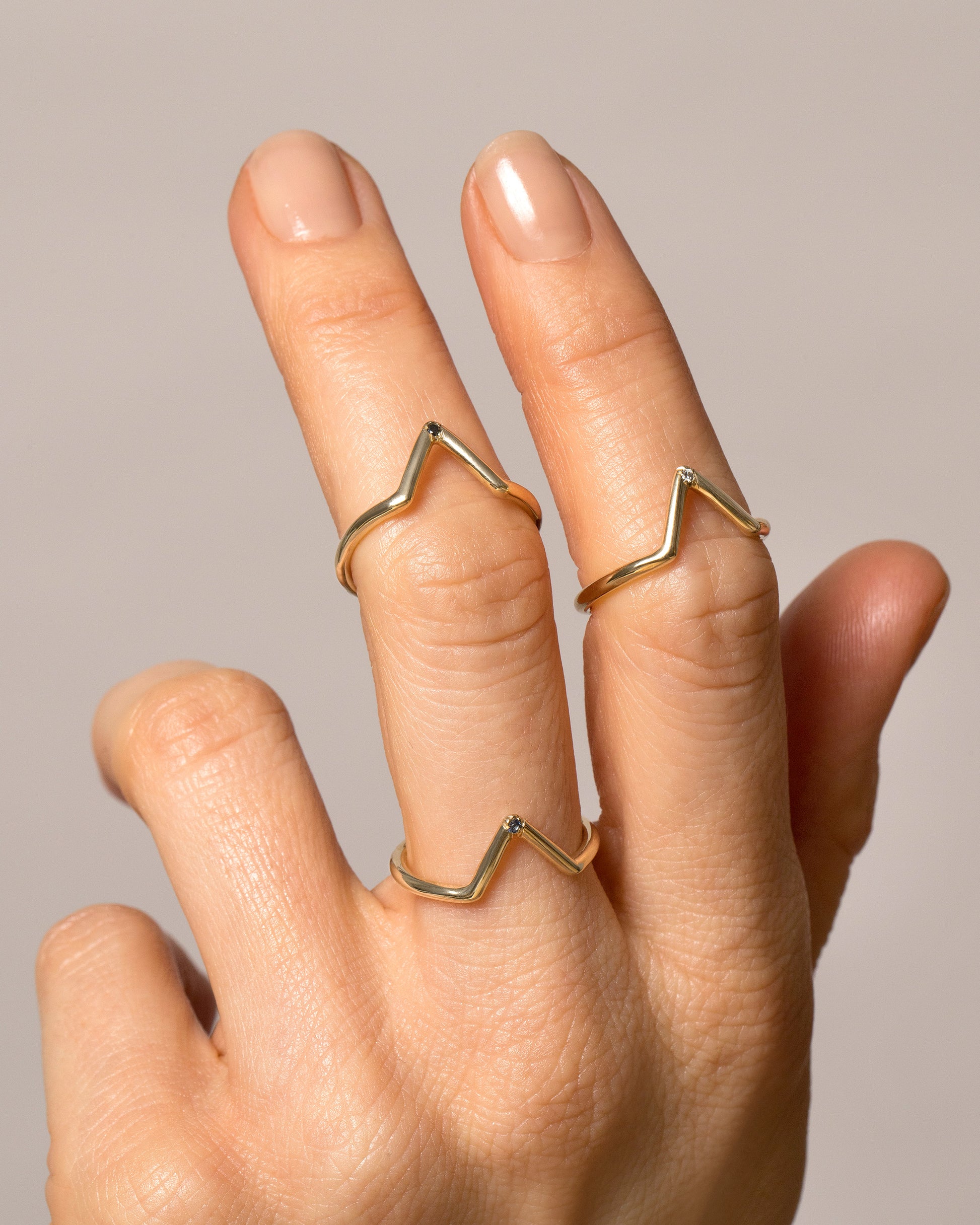 Gold Single Burnish-Set Stone Triangle Bands on model.