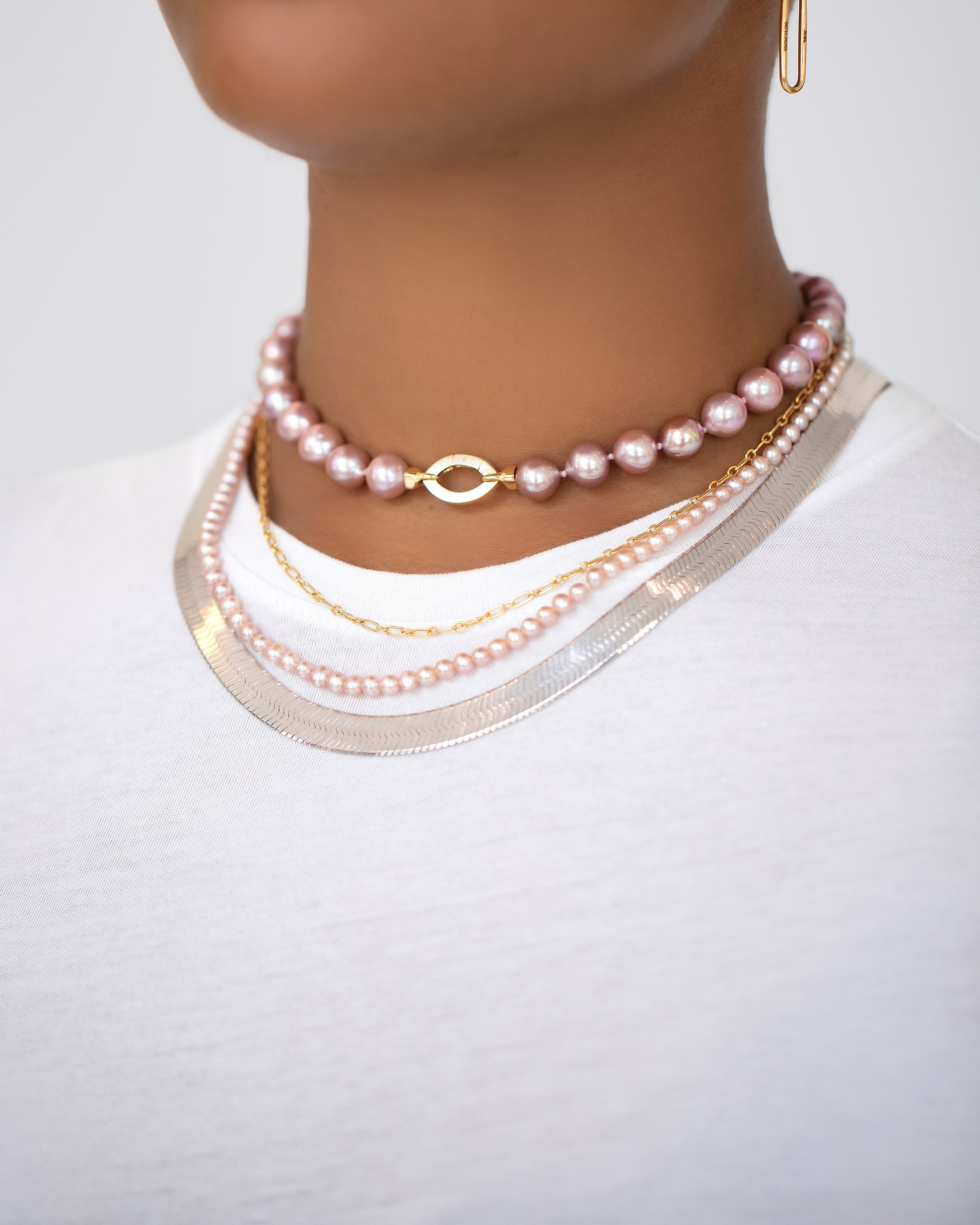 Cormorant Pearl Necklace, Hot Dog Chain Necklace, Seed Pearl Necklace and Silver Herringbone Chain on model.