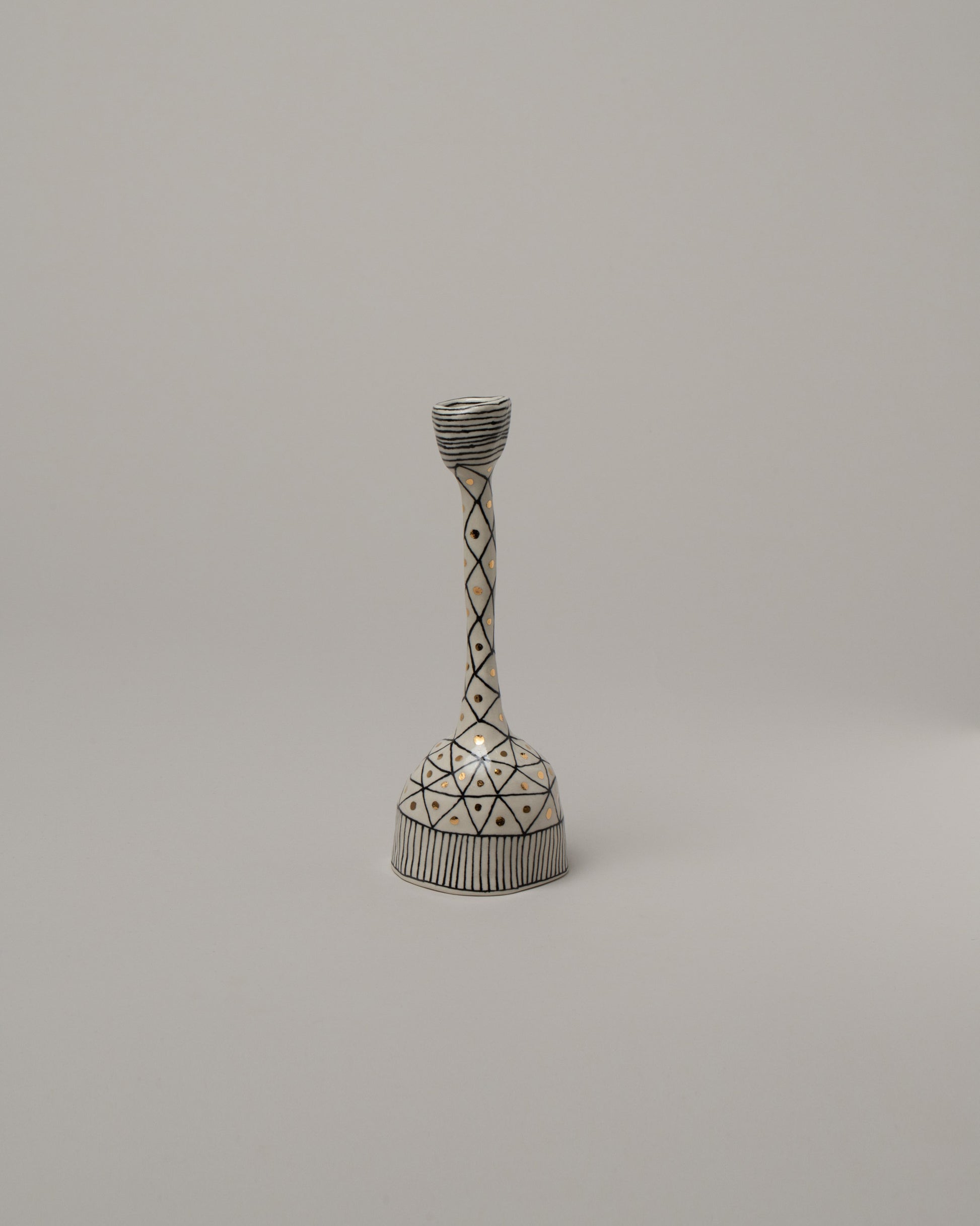 Suzanne Sullivan Nine Candlestick on light color background.