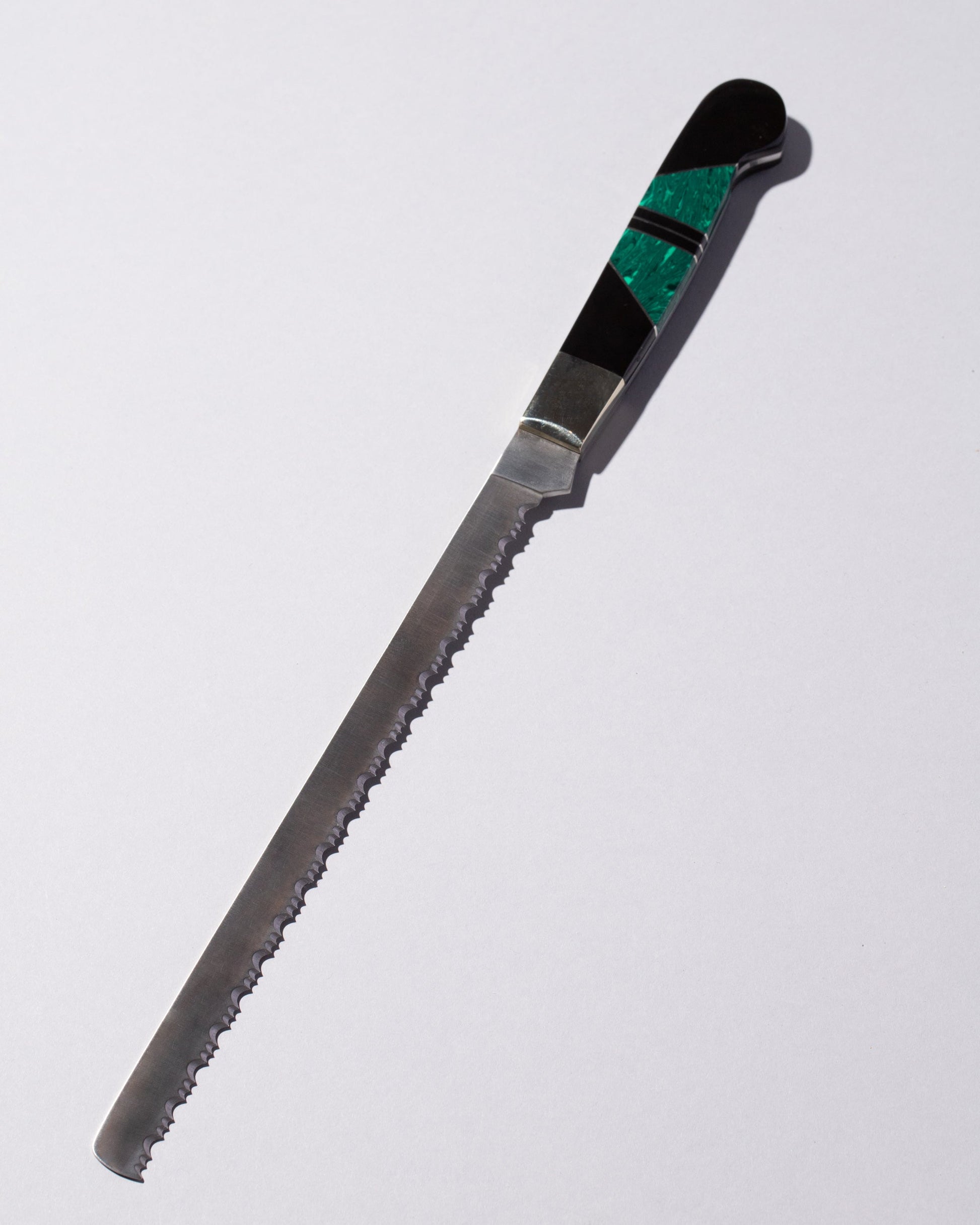 Santa Fe Stoneworks Jet & Malachite Bread Knife on light color background.