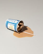 View from the side of the Spills Faux Diner Coffee To-Go Spill on light color background.