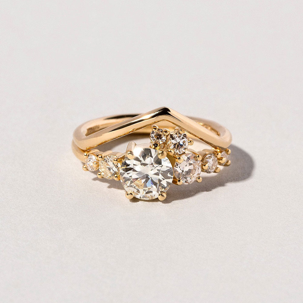 product_details::Luna Ring and White Diamond Round Wire Yellow Gold Luna Peak Band on light color background.