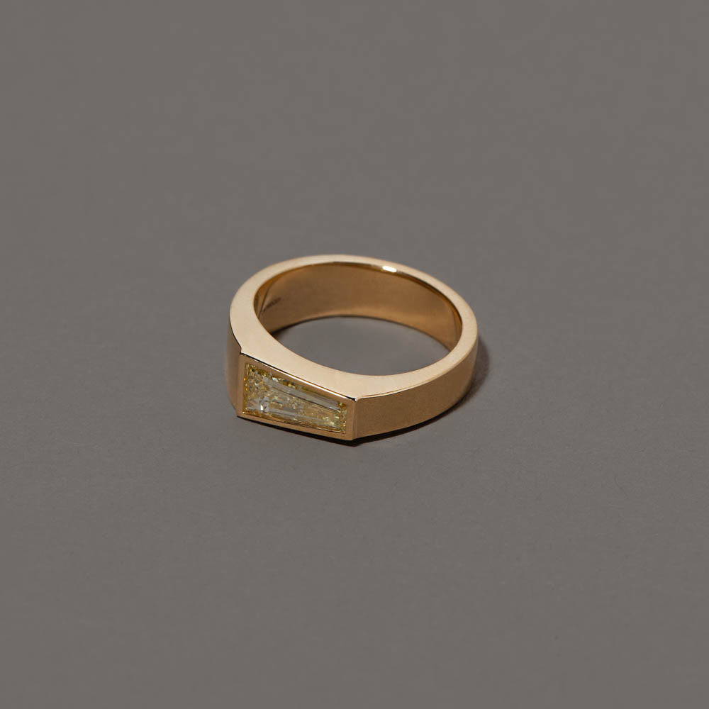 product_details::Closeup details of the Joviality Ring on grey color background.