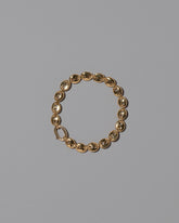 CRZM Gold Mini Bedrock Bracelet on light color background.