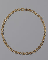 CRZM Gold Yuba Mini Necklace on light color background.