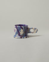 Echo Park Pottery by Peter Shire Round Handle Blue Splatter Mug on light color background.