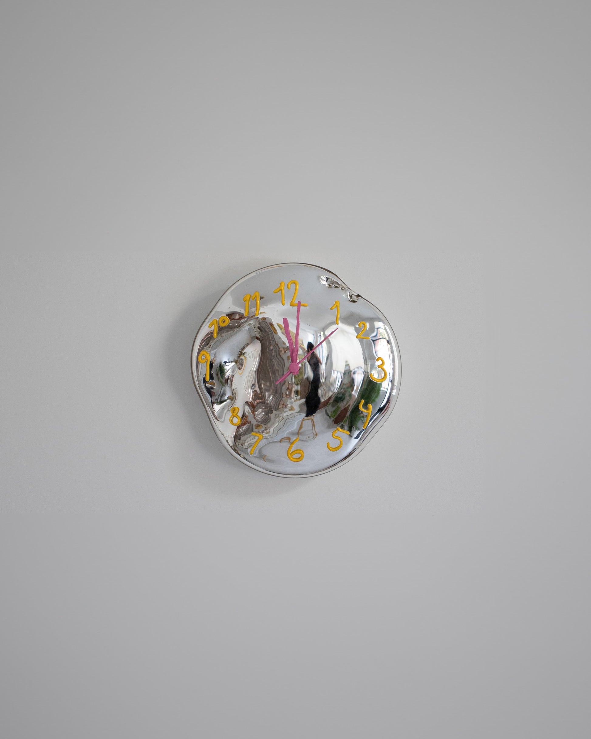 Silje Lindrup Yellow Glass Wall Clock on light color background.