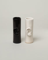 Group of Bonam Kim Black and White Ear Pillar Vases on lightcolor background.