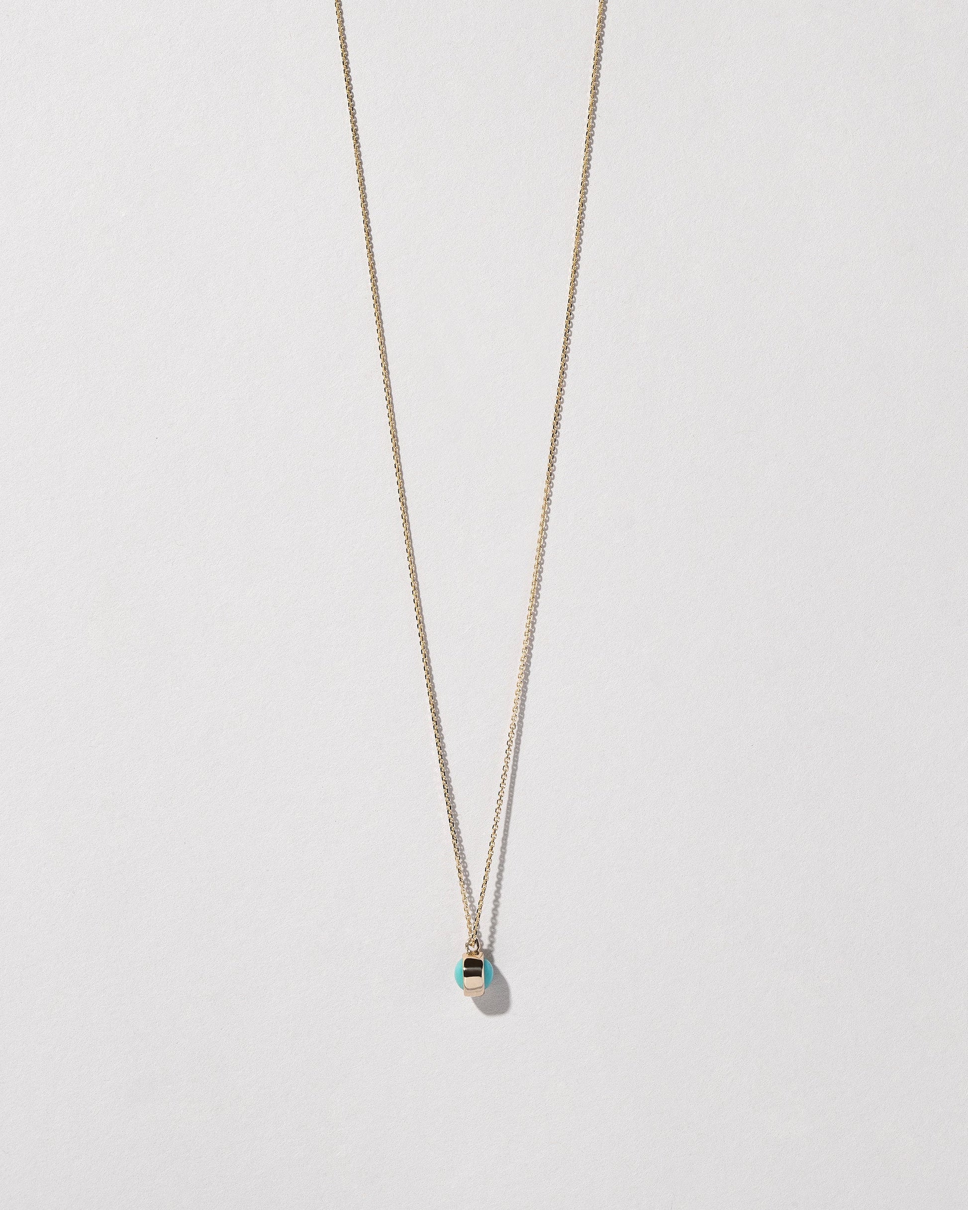 Turquoise Birthstone Necklace on light color background.