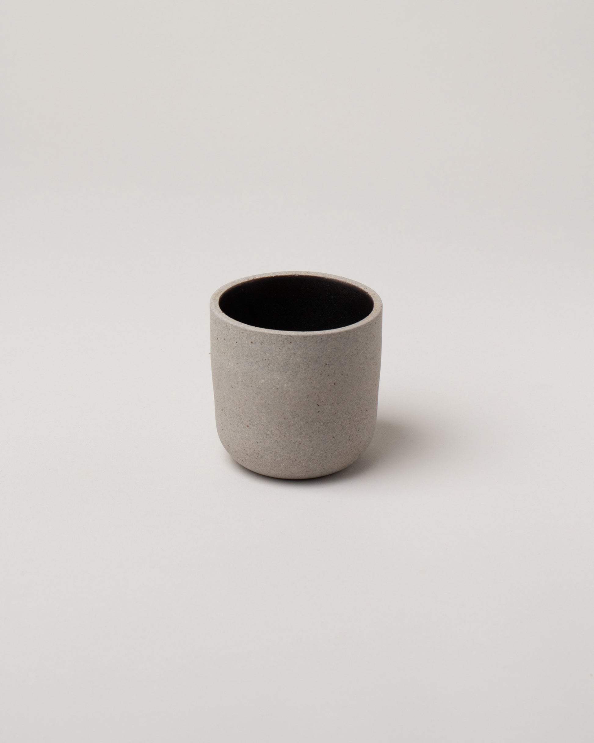 Humble Ceramics Greystone & Matte Black Small Alder Tumbler on light color background.