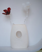 Styled image featuring the Alex Rosenbaum Ghost Glass Flower and Red Glass Flower with the Stephanie Phillips Single Barrel Vessel.