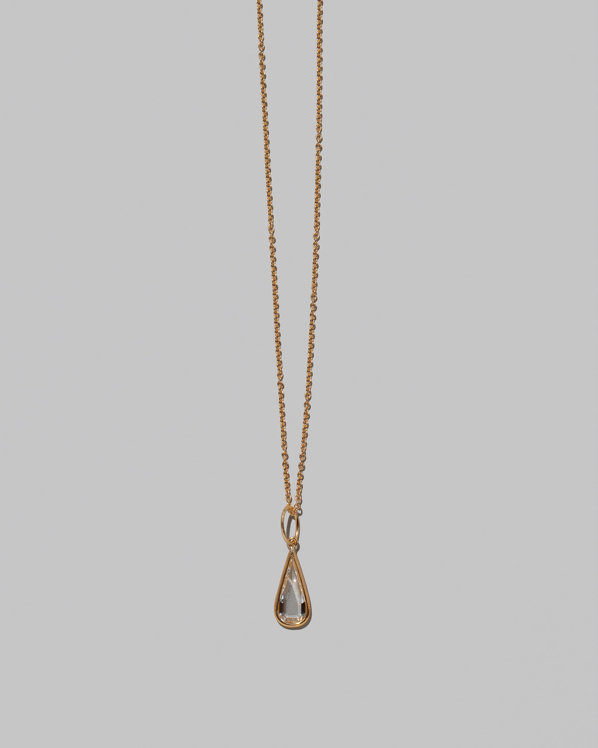 Closeup details of the State Shifter Diamond Pendant paired with chain on light color background.