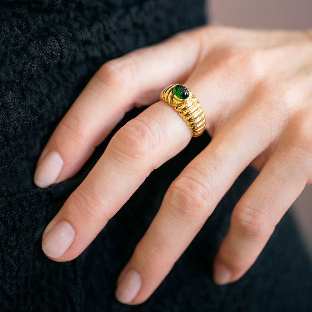 product_details::Vintage Ribbed Peridot Ring on model.