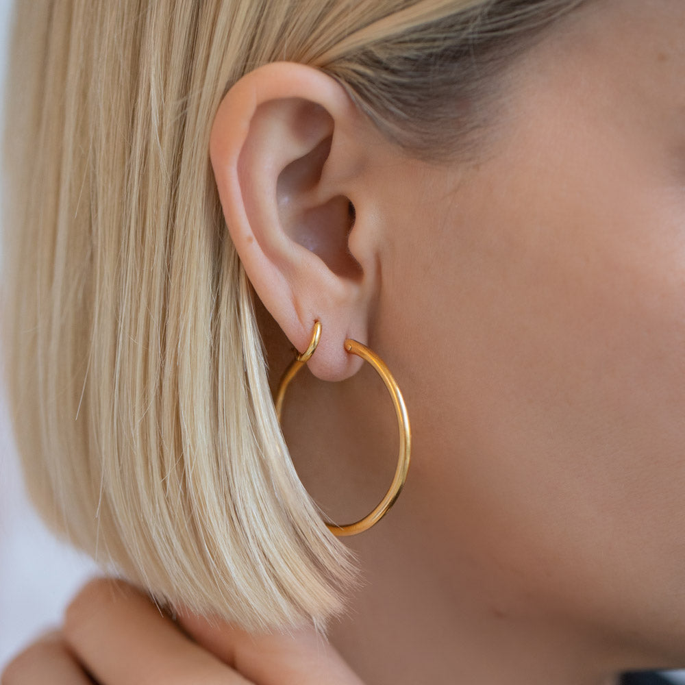 product_details::Vintage Blvgari Hoop Earrings on model.