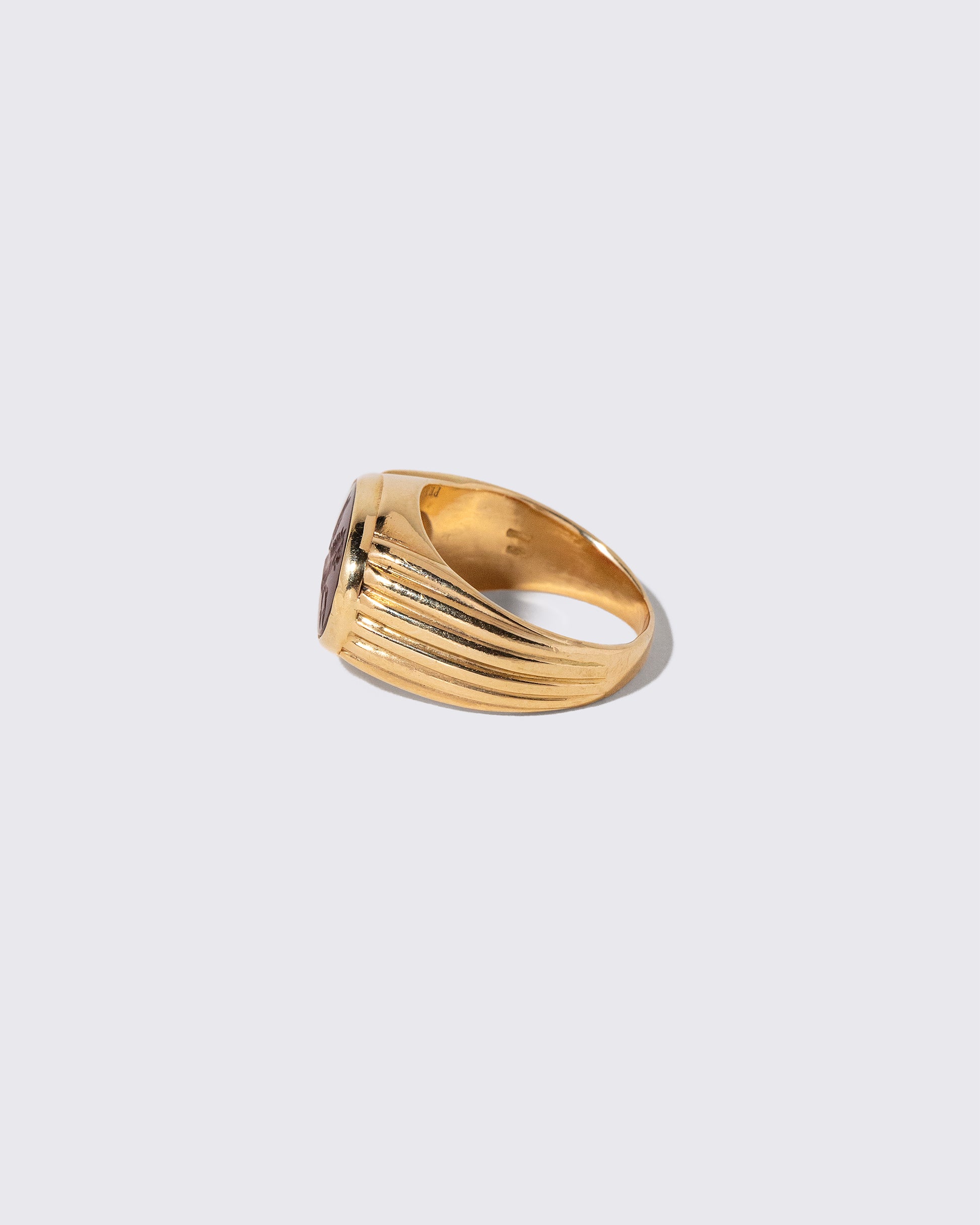 Detail view of the Vintage Bvlgari Carnelian Pegasus Intaglio Ring on light color background.