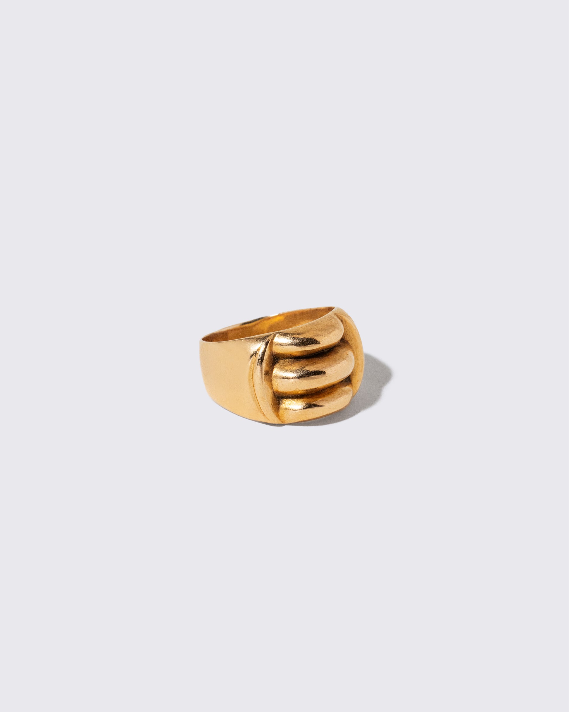 View from the side of the Vintage Gold Gadroon Ring on light color background.