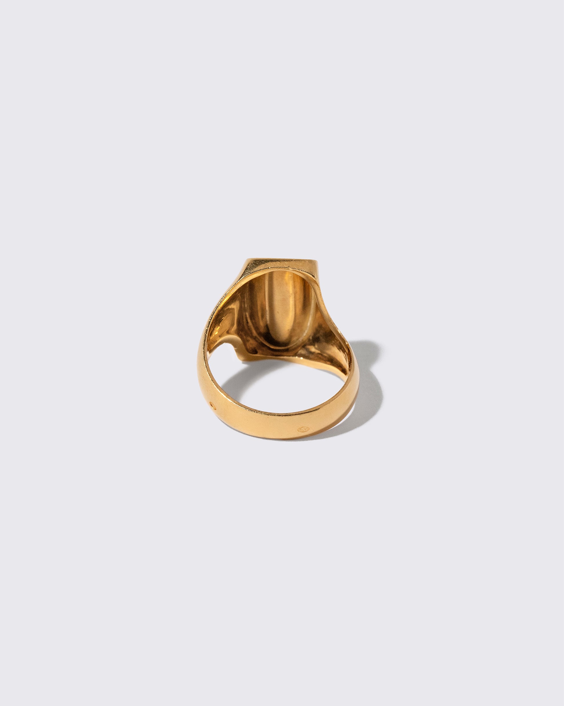 View from the back of the Vintage Gold Saddle Ring on light color background.