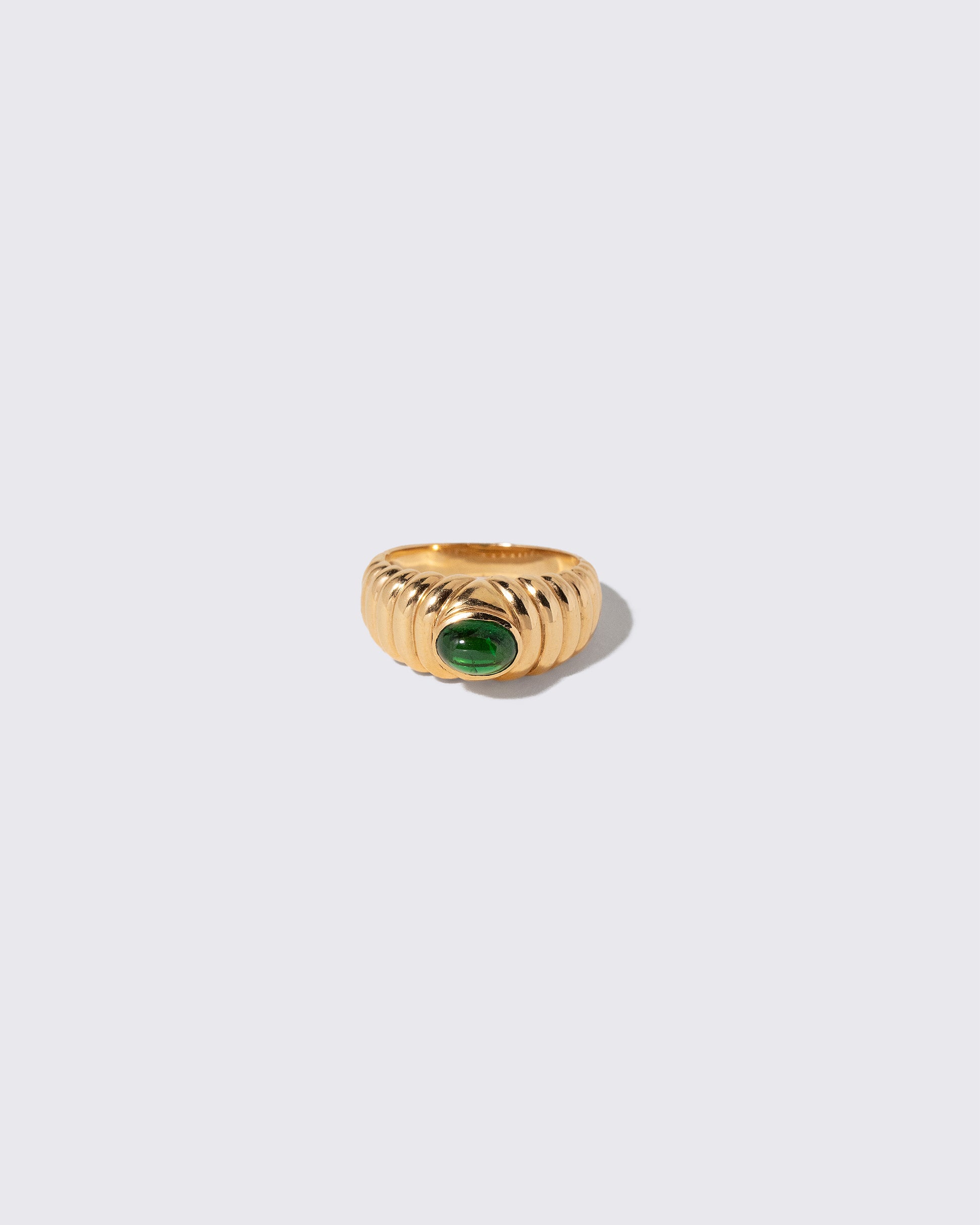 Vintage Ribbed Peridot Ring on light color background.