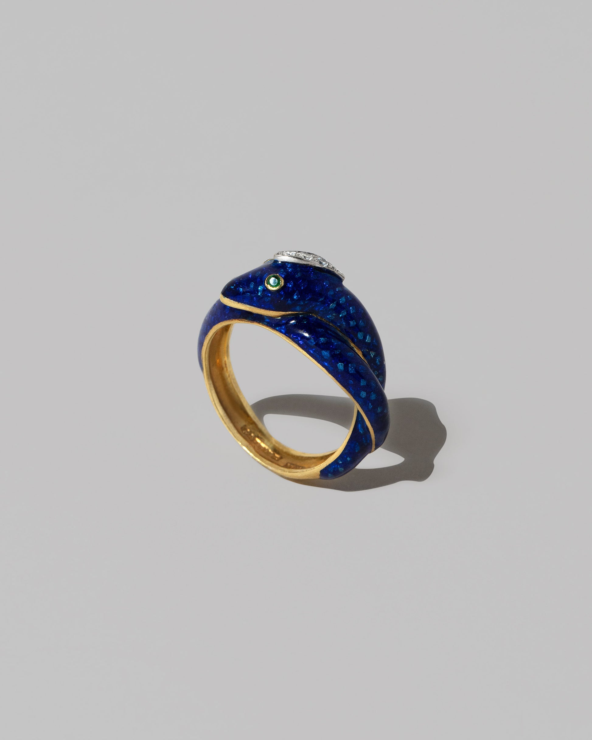 Vintage Cartier Enamel Snake Ring on light color background.