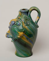 View from the side of the Apotropaia Medium Head Jug One on light color background.