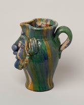 View from the side of the Apotropaia Small Head Pitcher on light color background.