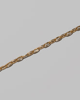 Closeup details of the Wavy Link Chain Bracelet on light color background.