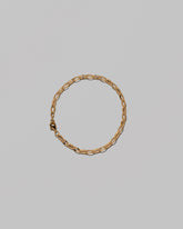 Flat Oval Link Chain Bracelet on light color background.