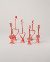 Group of La Romaine Editions Heart-Shaped Candle Holders on light color background.