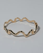 Samples & Imperfects Yellow Gold Large Cut-Outs Bracelet on light color background.