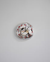 Silje Lindrup Brown Hands Red Glass Wall Clock on light color background.