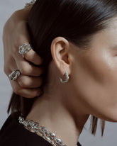 Styled image featuring CRZM jewelry on model.