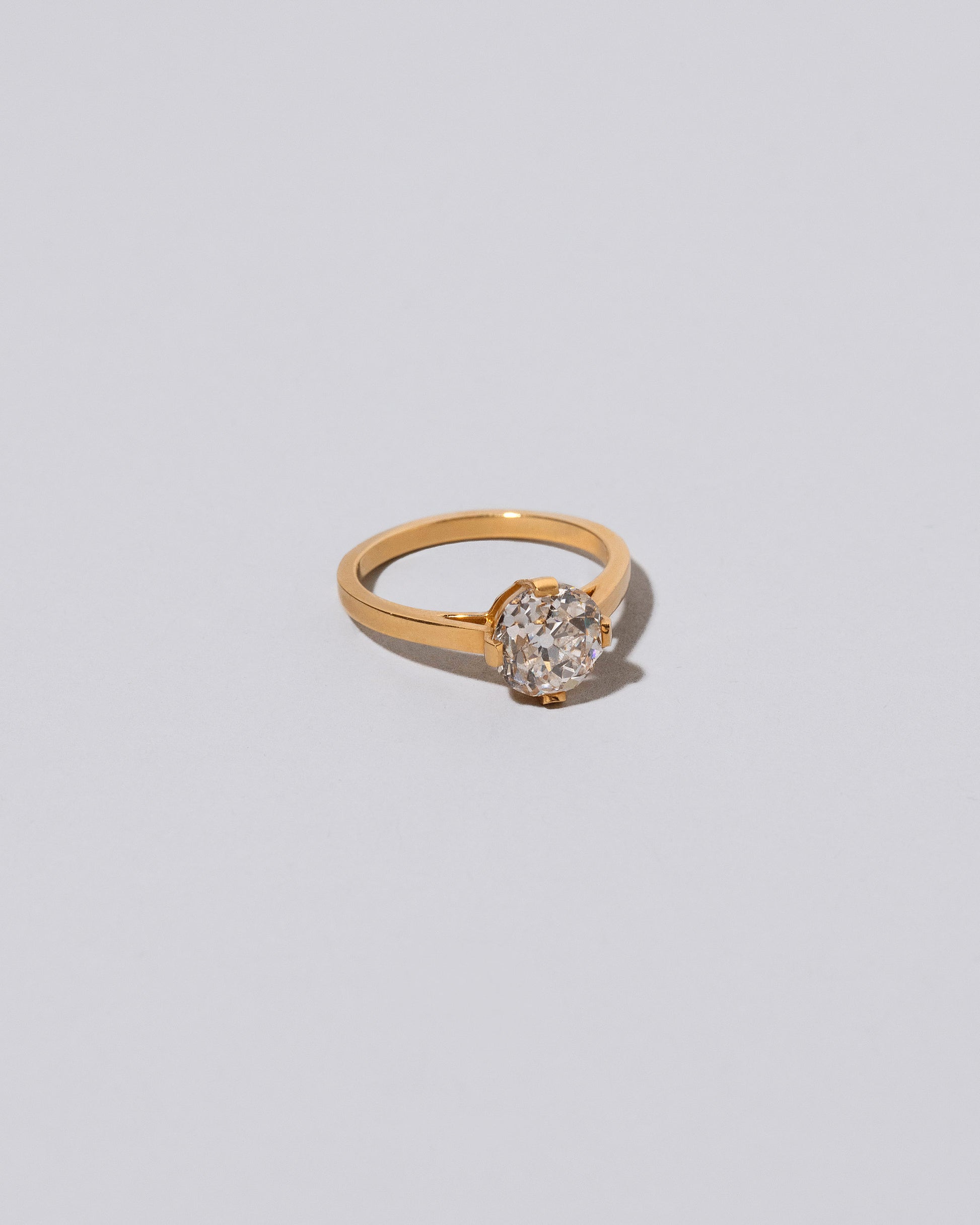 View from the side of the White Diamond Barragán Ring on light color background.