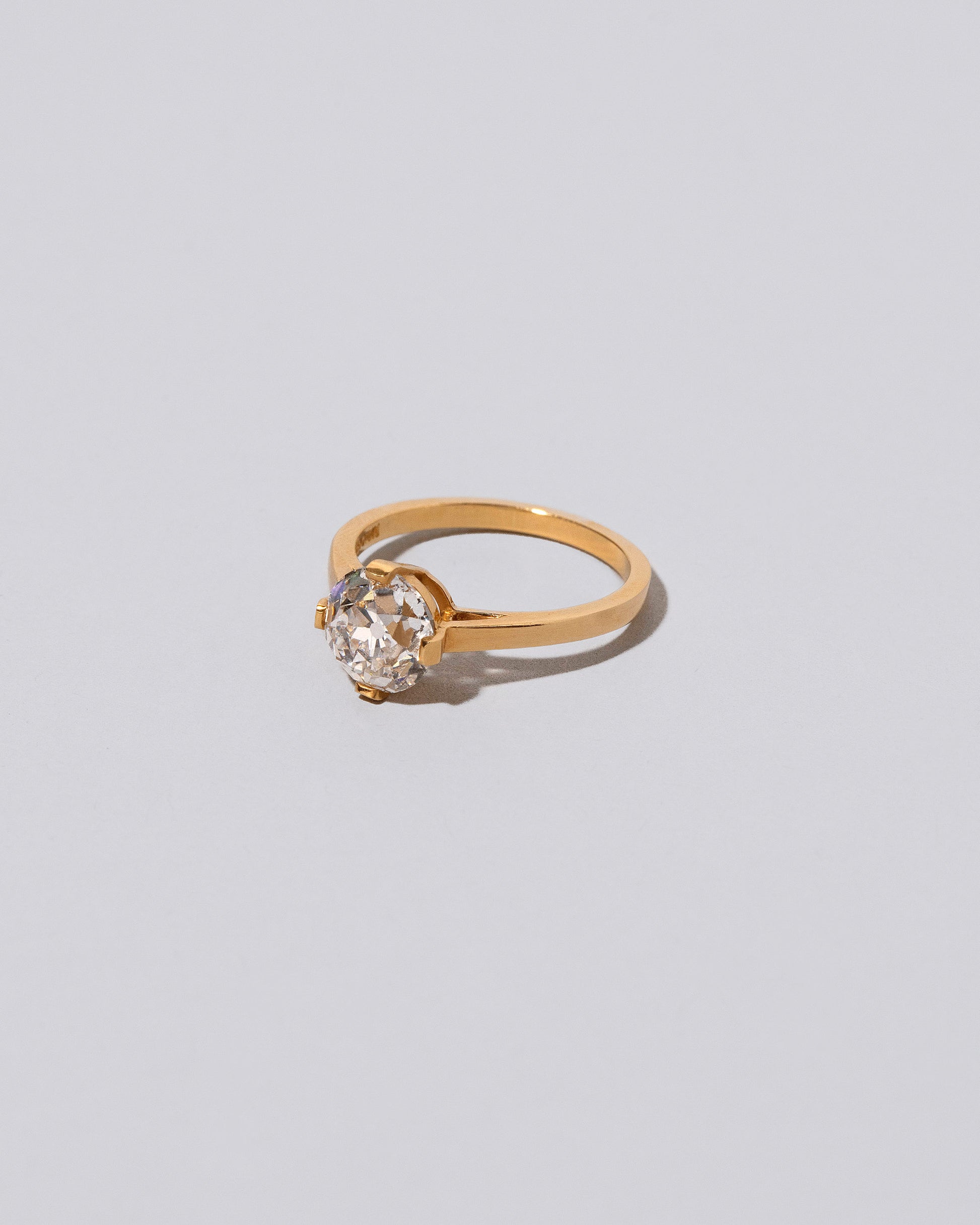 View from the side of the White Diamond Barragán Ring on light color background.