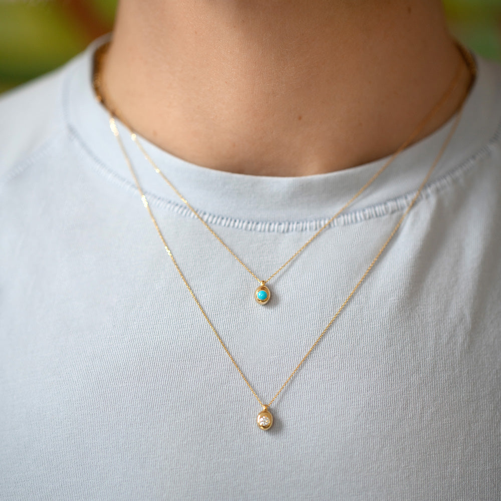 product_details::Diamond Birthstone Level Necklace and Turquoise Cabochon Birthstone Level Necklace on model.