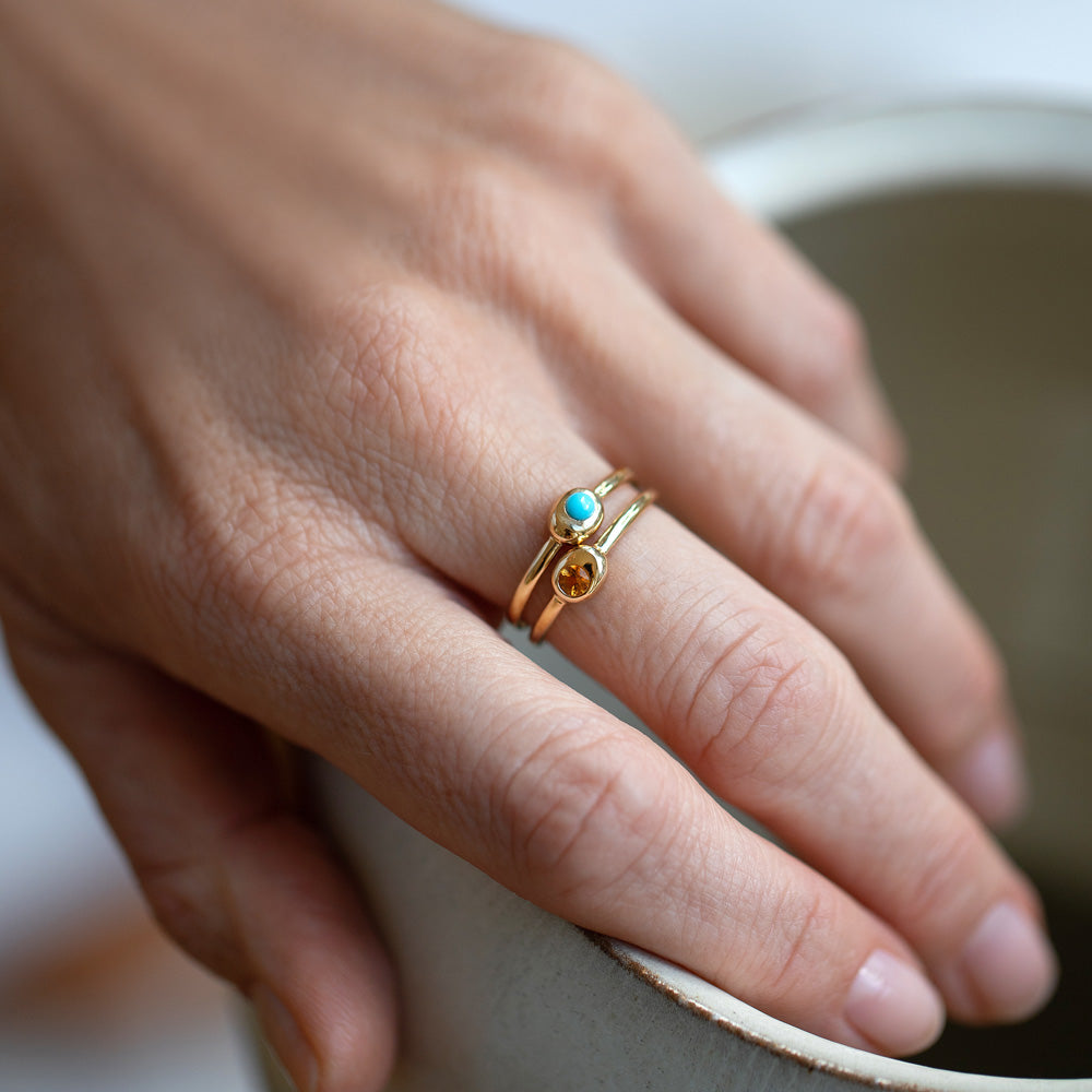 product_details::Citrine Birthstone Level Ring and Turquoise Cabochon Birthstone Level Rings on model.