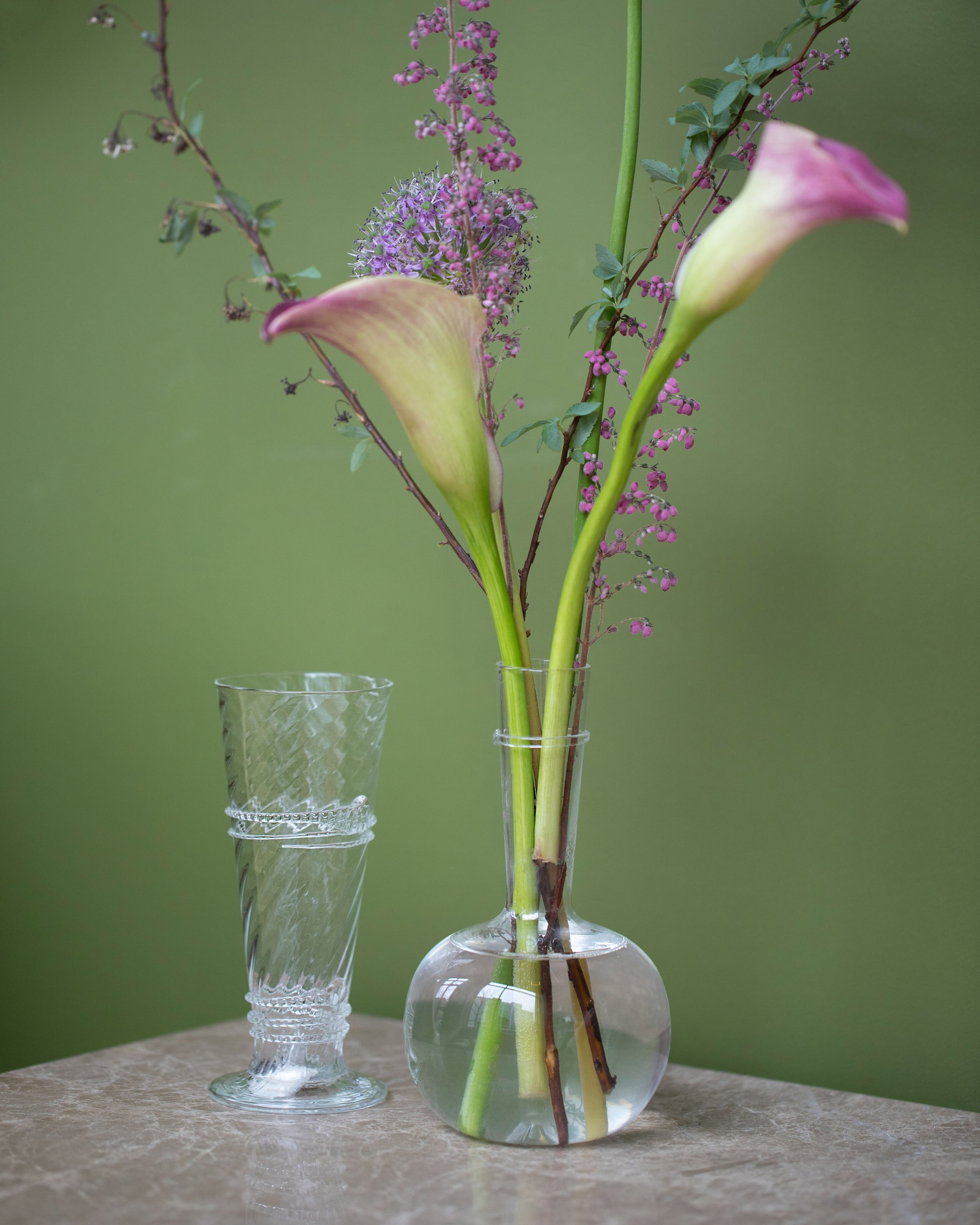 Styled image featuring the Bollenglass Design Clear Small Spiral Vase and Clear Bud Vases.