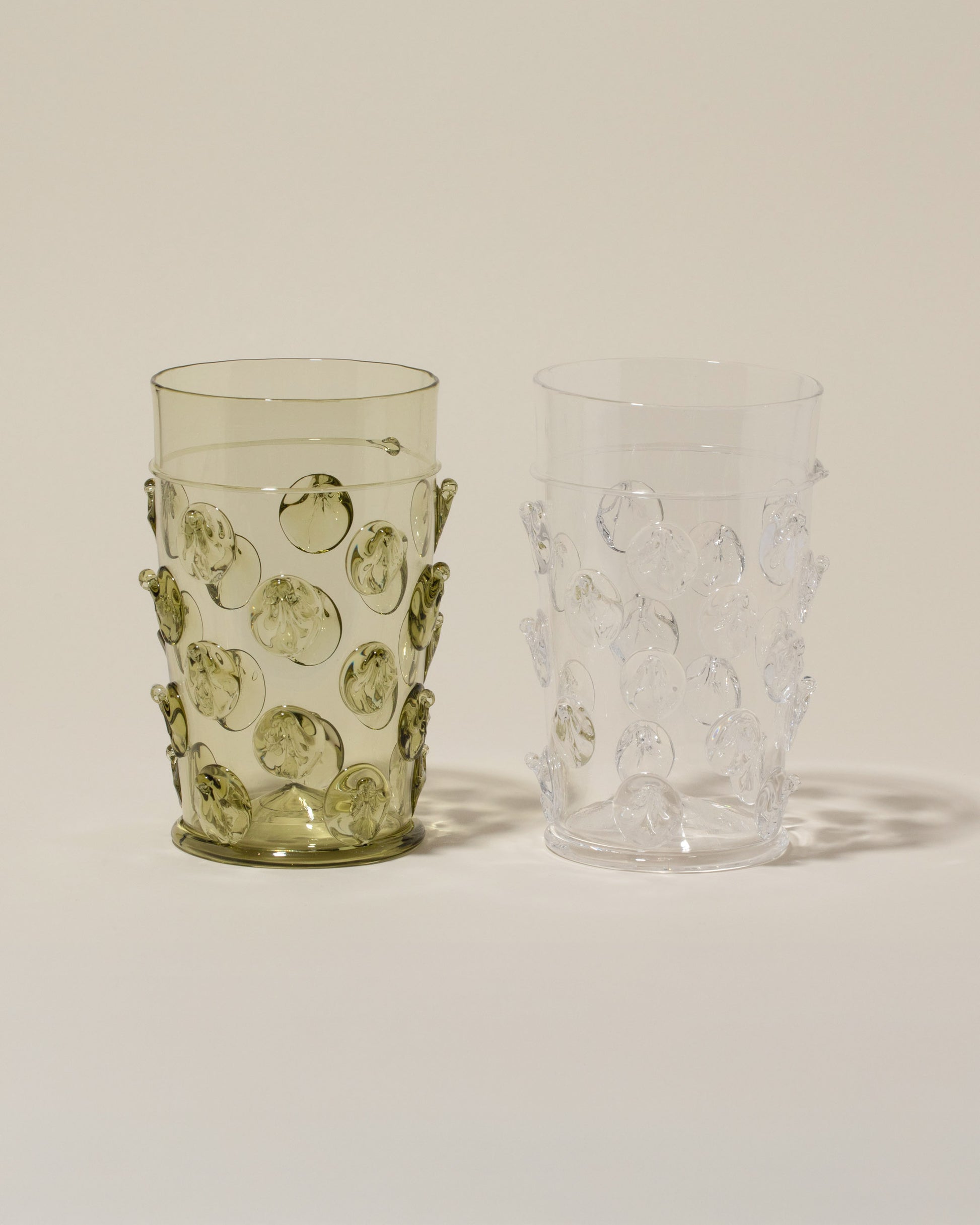 Bollenglass Design Green Dot Beer Glass and Clear Dot Beer Glass on light color background.