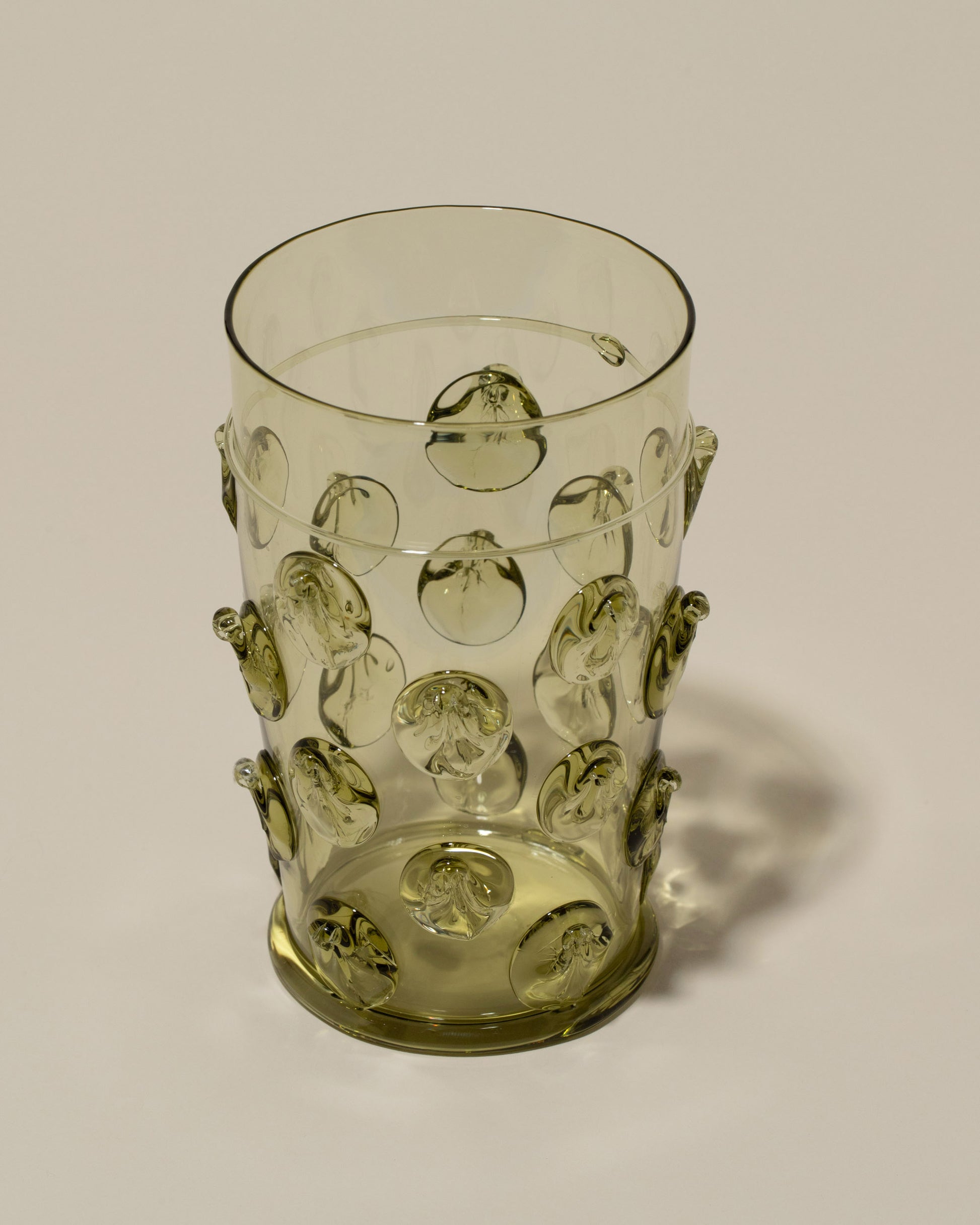 Closeup details of the Bollenglass Design Green Dot Beer Glass on light color background.