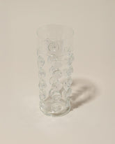 Closeup details of the Bollenglass Design Clear Dot Water Glass on light color background.